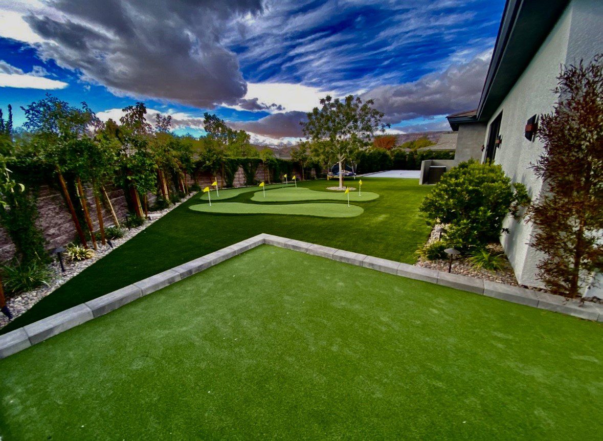 Backyard with putting green and cloudy sky.