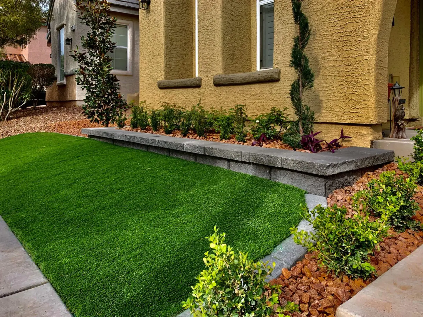A green lawn in front of a house.